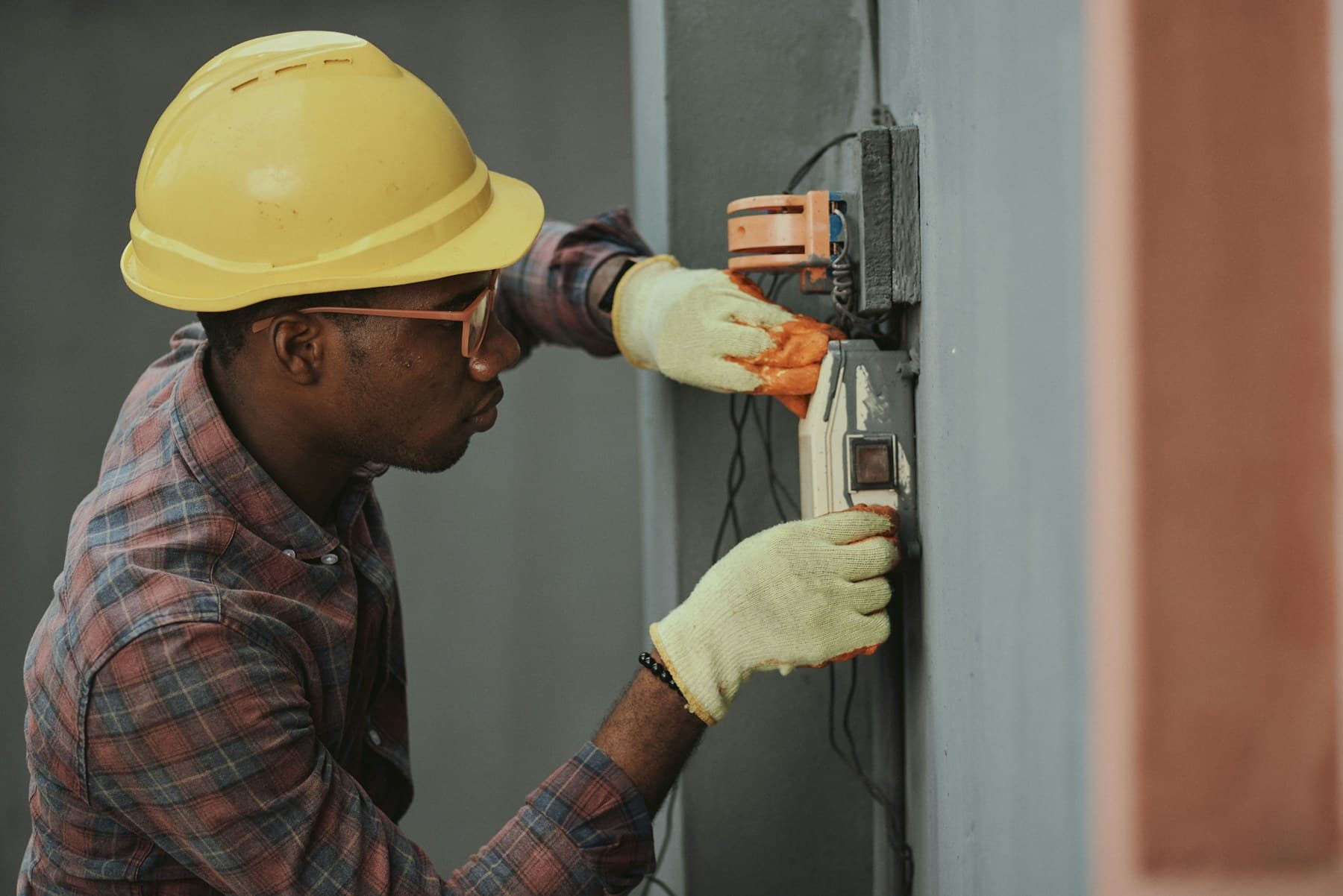 An electrician wiring a panel