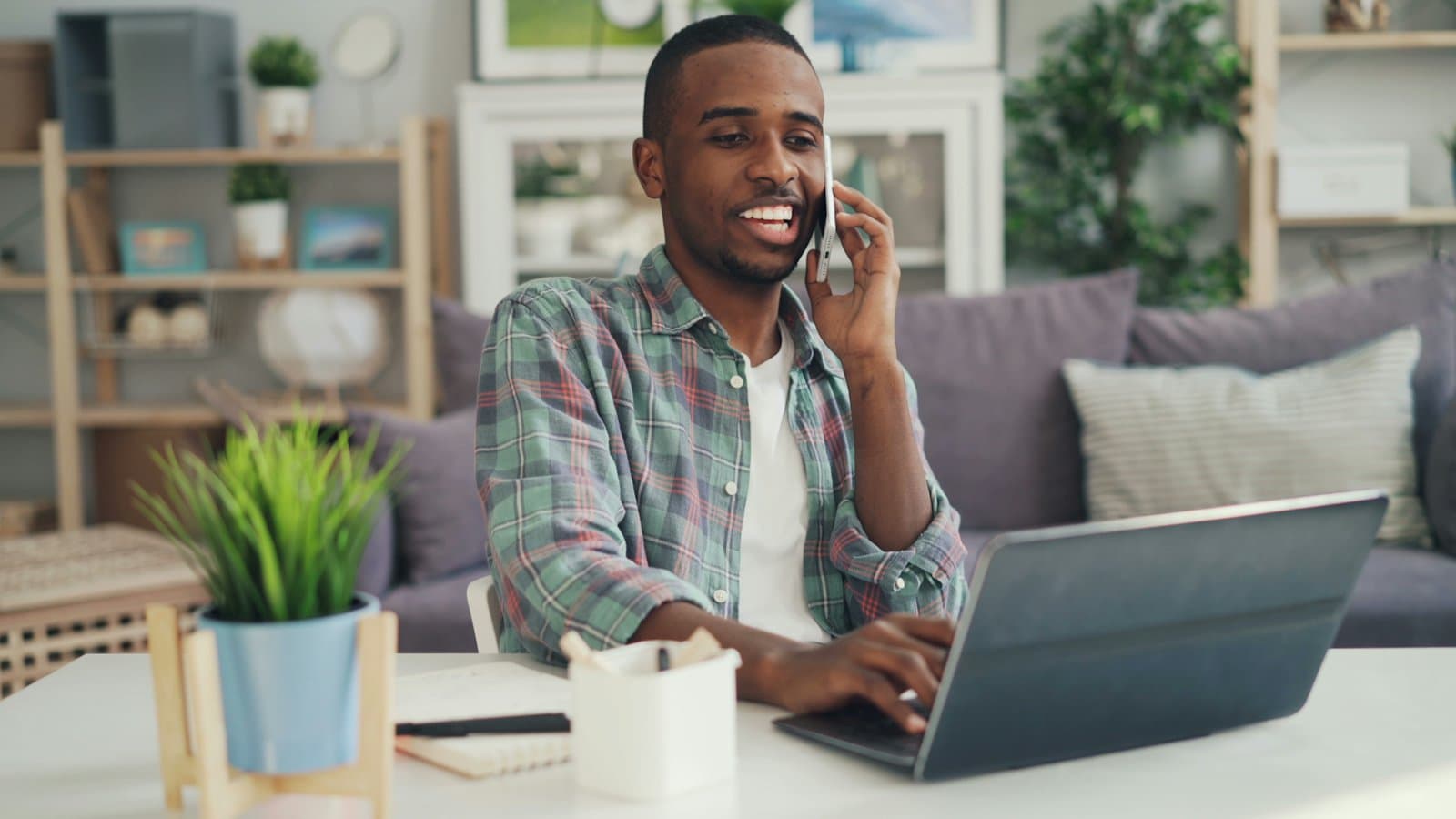 A man on the phone at a laptop